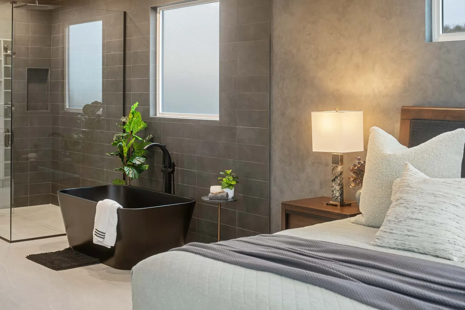Primary bedroom with a freestanding tub beside the bed