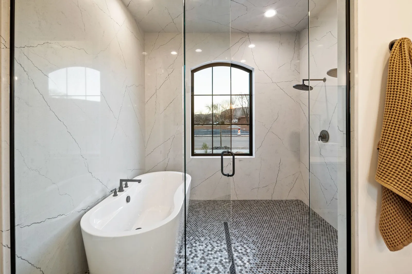 Bathroom with a freestanding tub and a glass shower