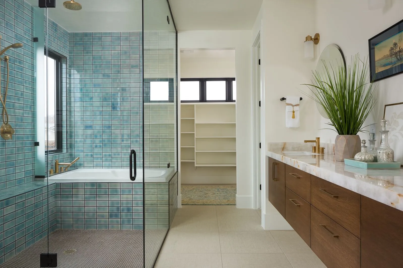 Bathroom with a blue-tiled shower and a soaking tub