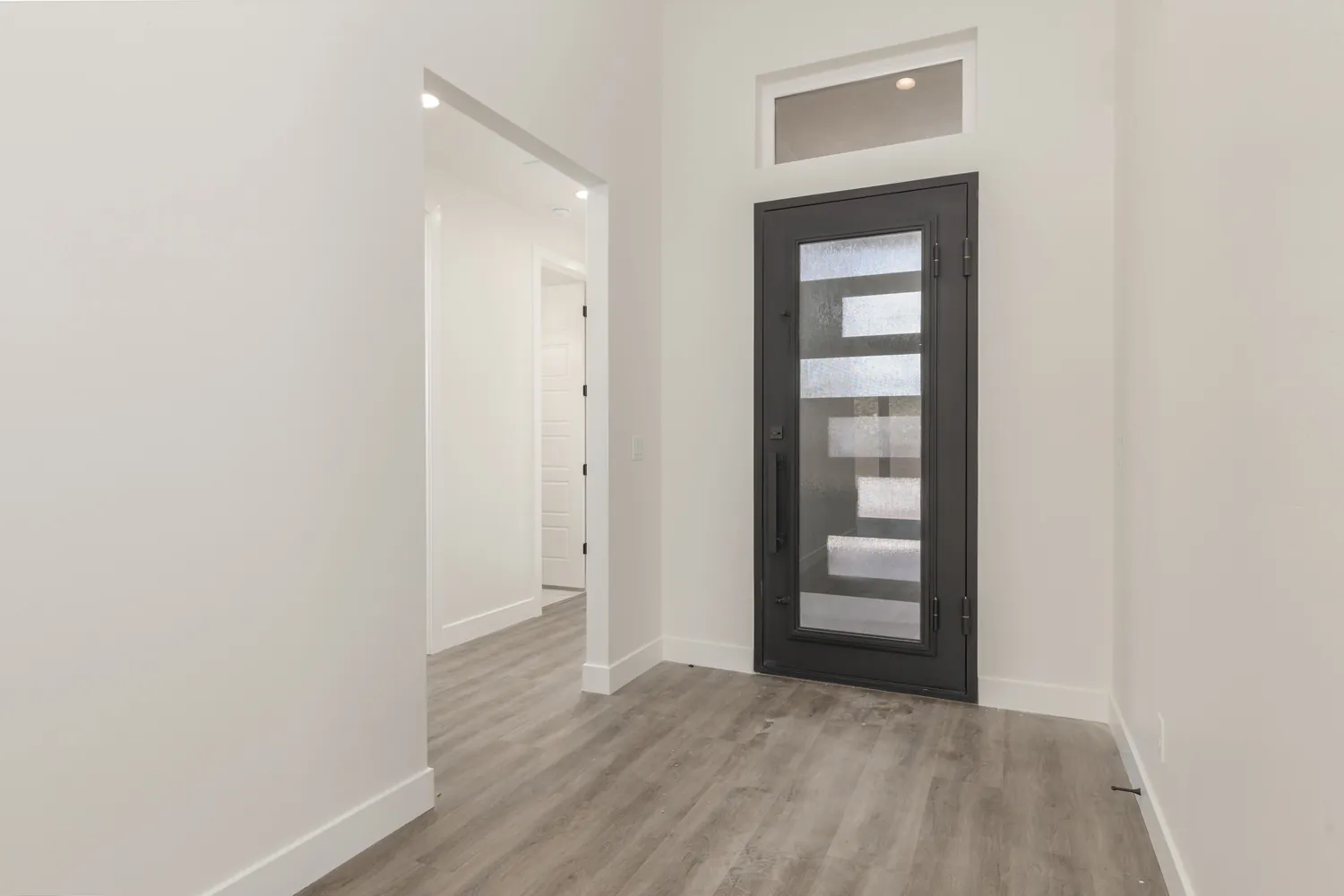 Entry with a black glass-panel front door