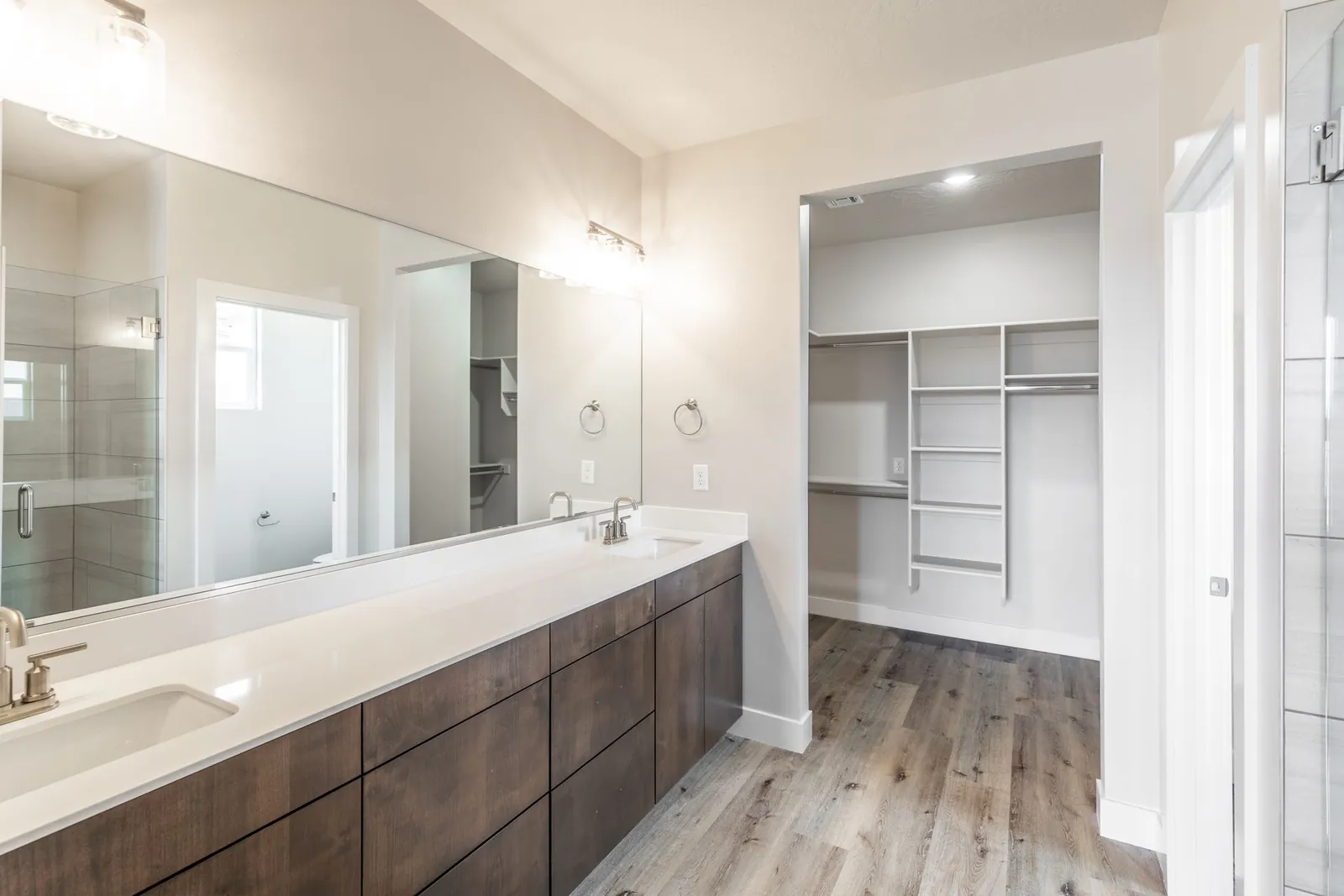 Double vanity with a walk-in closet beyond