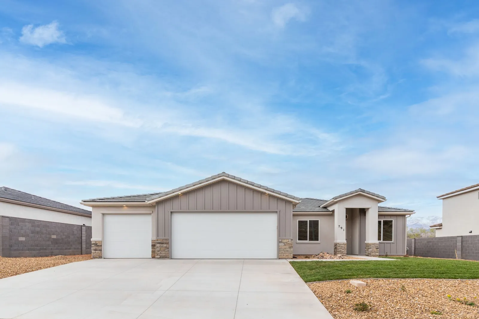 Single-story home with a gabled front and two garage doors