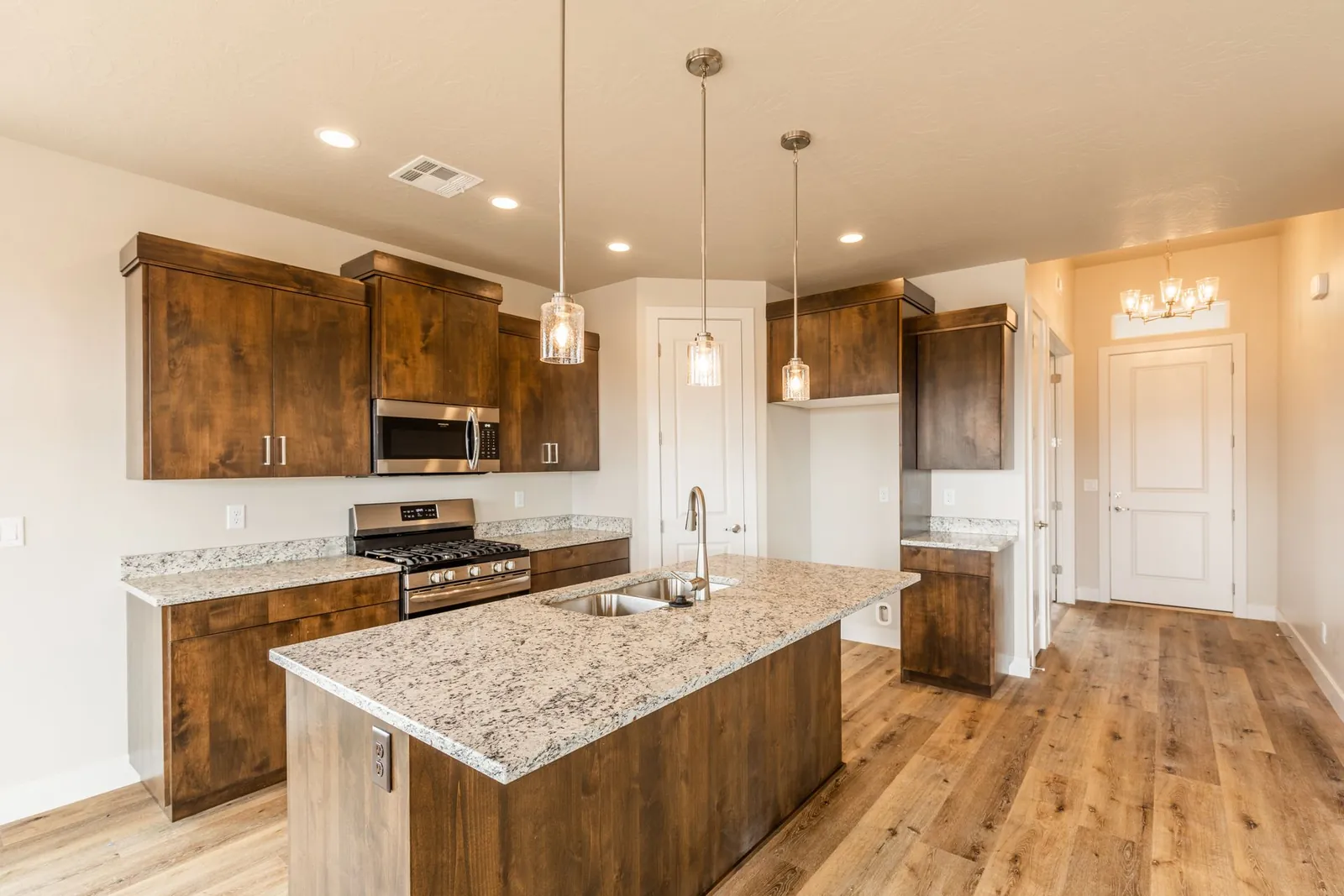 Kitchen with dark wood cabinets and a granite island