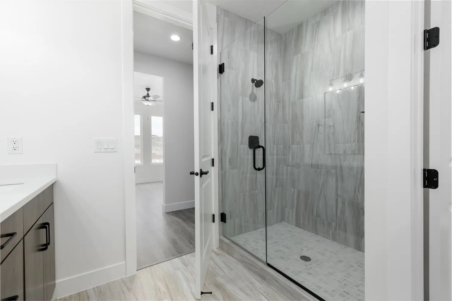 Walk-in tiled shower with a glass door