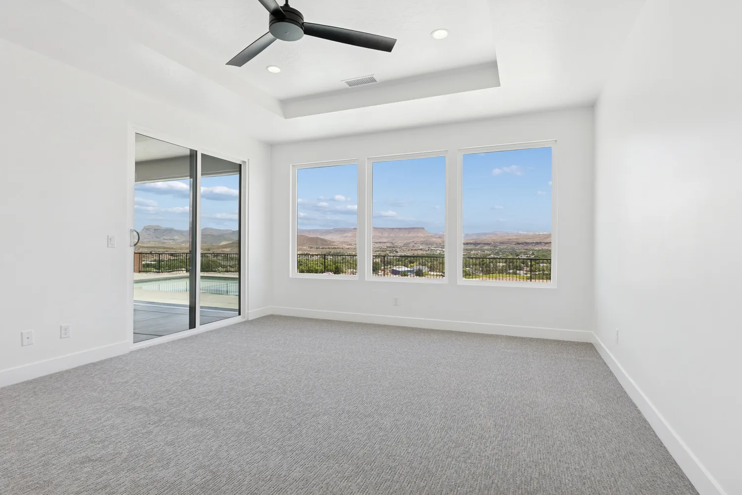Primary bedroom with windows toward the red cliffs