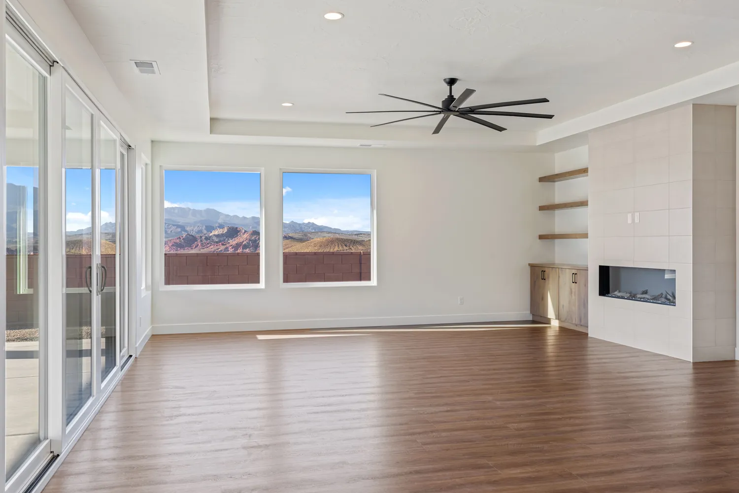 Great room with a linear fireplace and windows toward the mountains