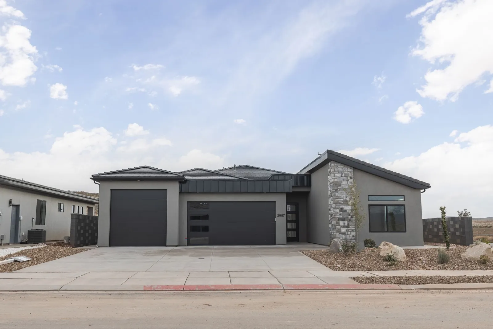 Single-story home with a stone column and two garage doors