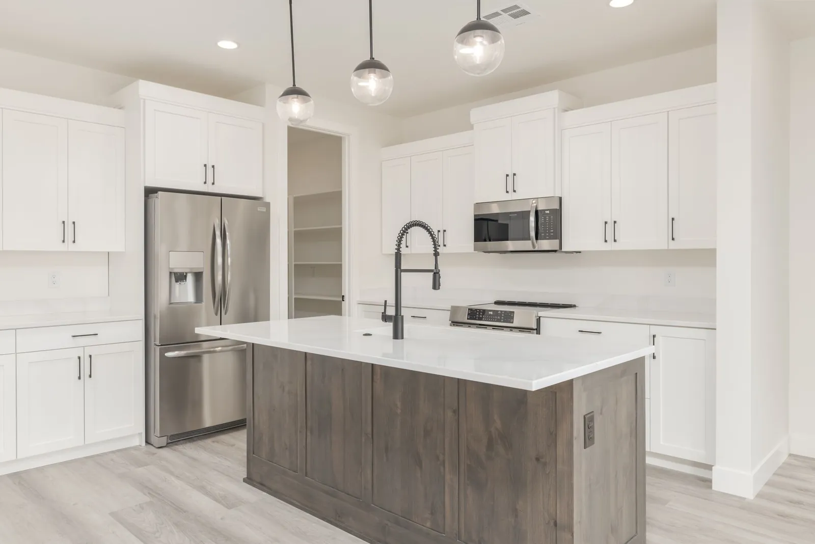 Kitchen with white cabinets and a wood island