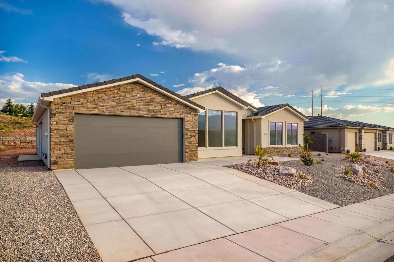 Single-story home with a stone garage wing