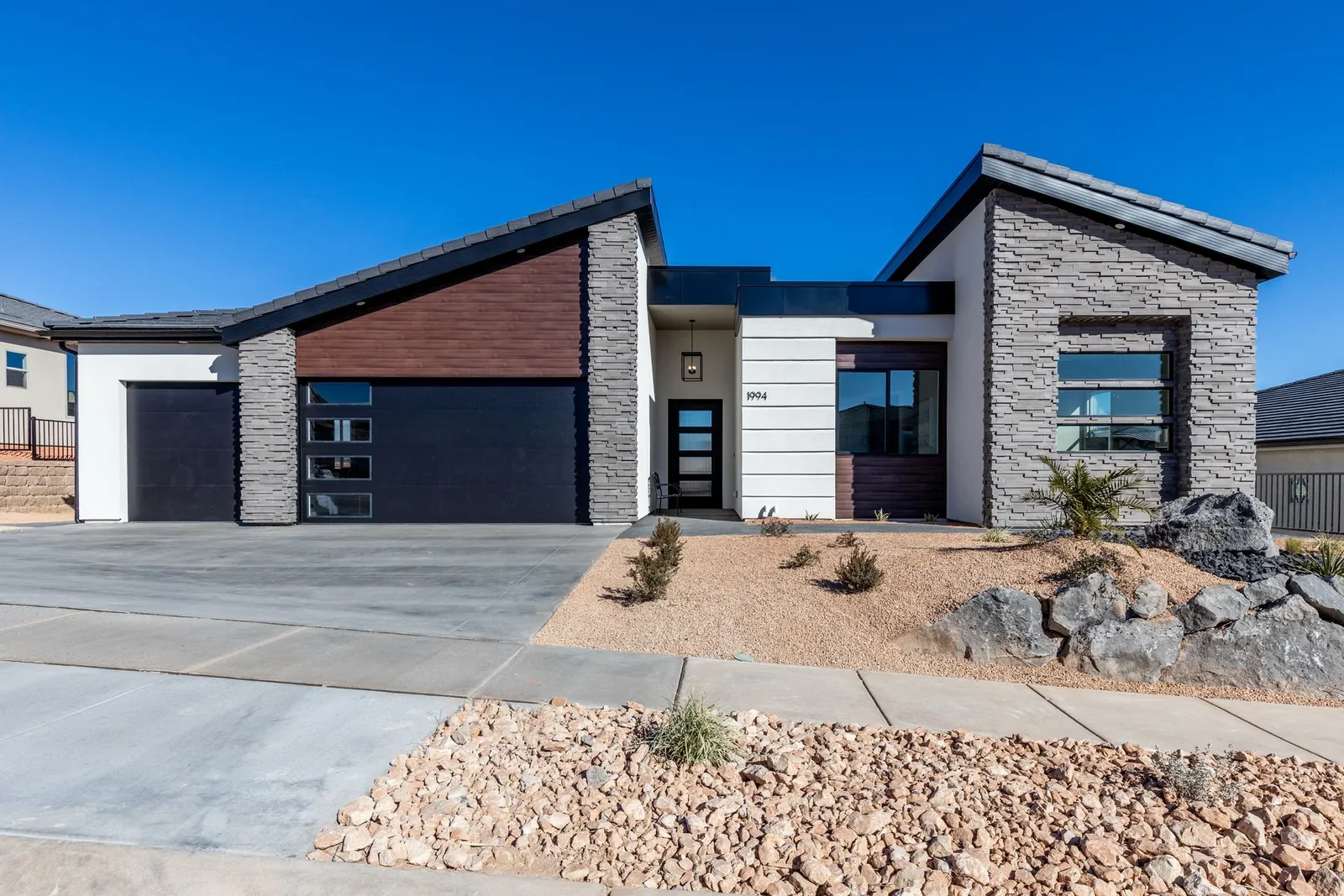 Modern home with shed roofs, stone and wood siding