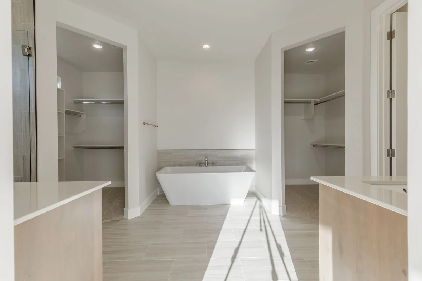 Freestanding tub in a bright primary bathroom