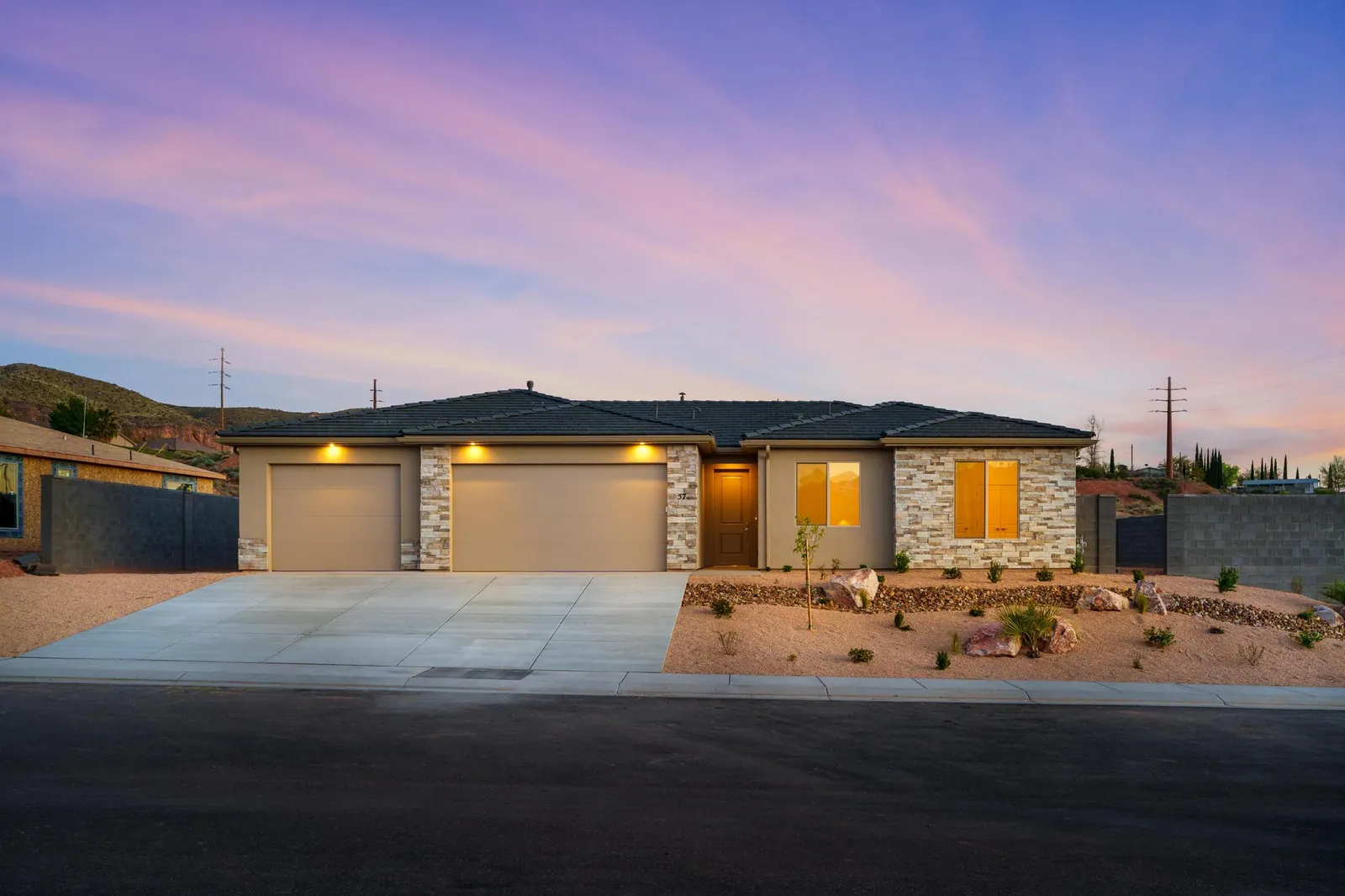 Single-story home at dusk with its lights on