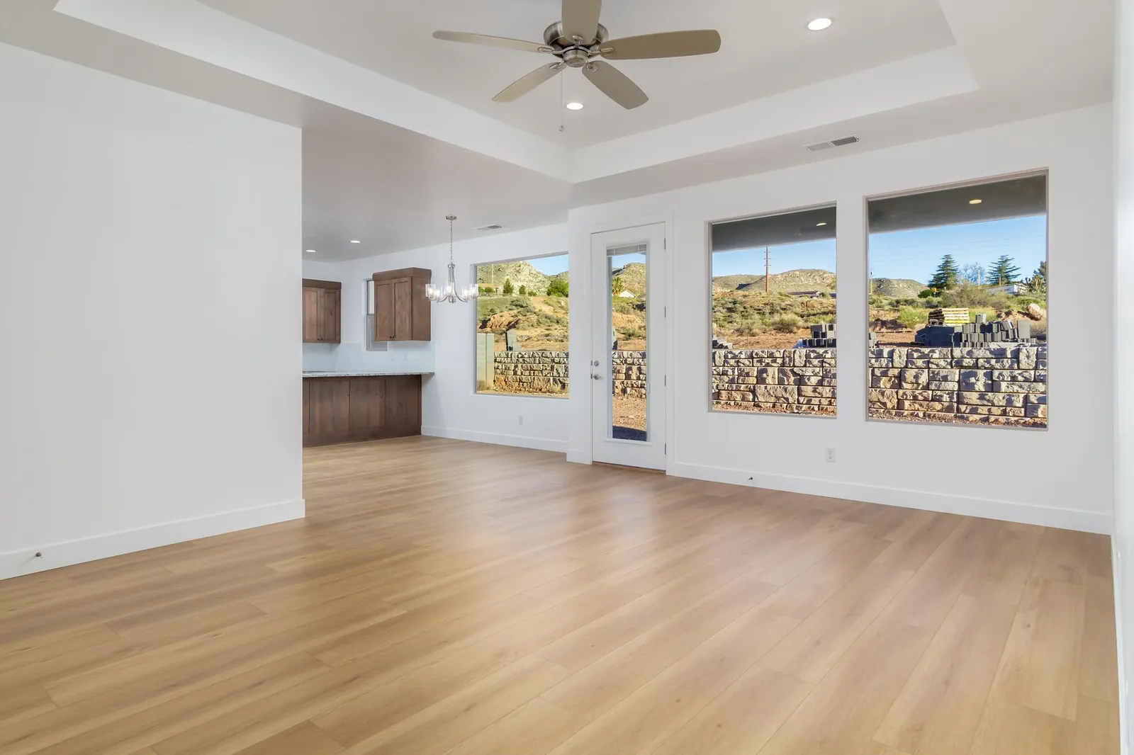 Great room with three windows toward the hills