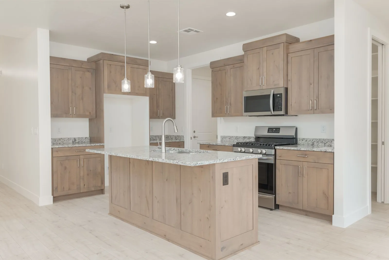 Kitchen with wood cabinets and pendant lights