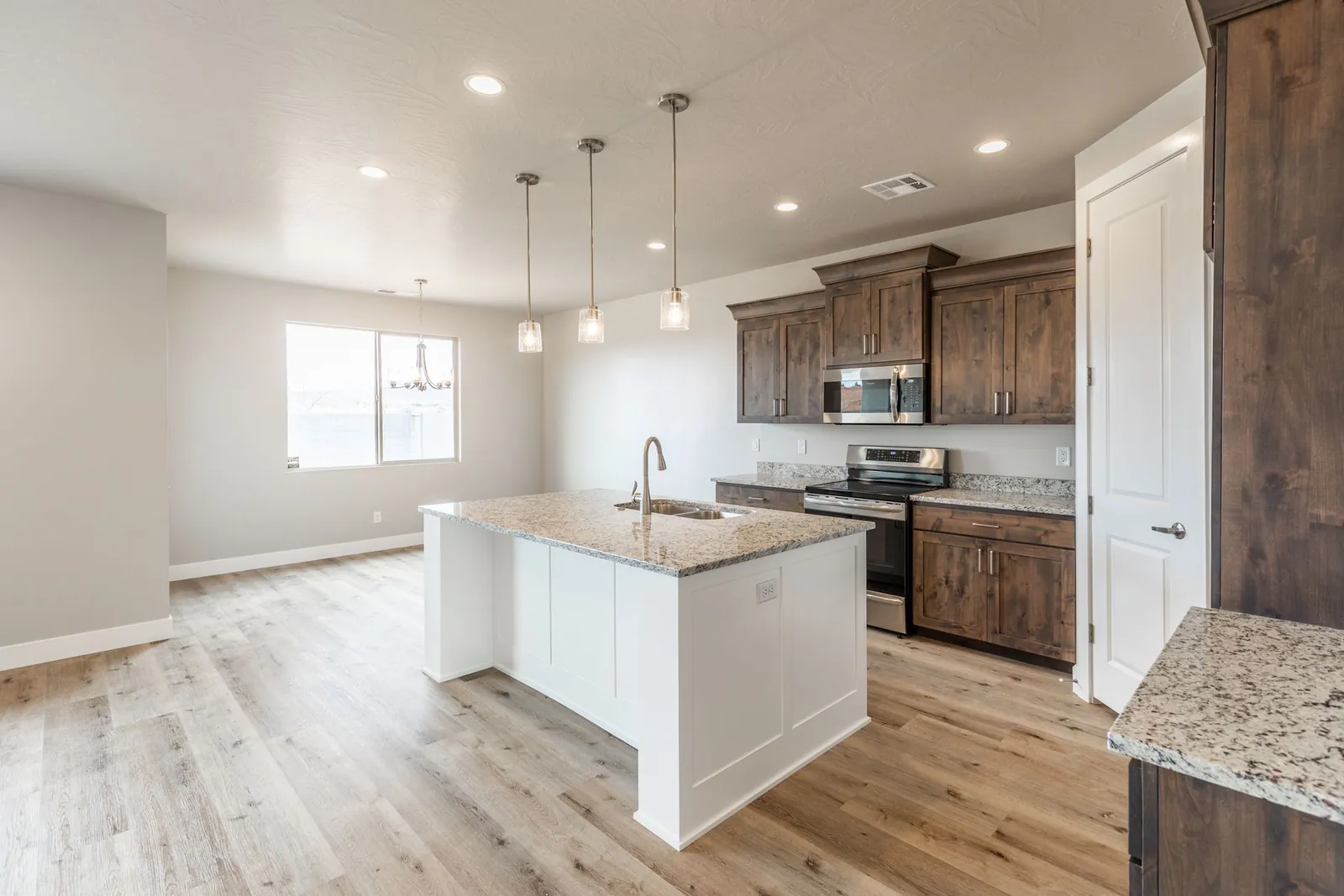 Kitchen with a white island and pendant lights