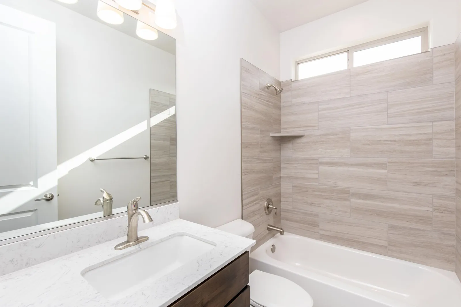 Bathroom vanity and a tiled tub