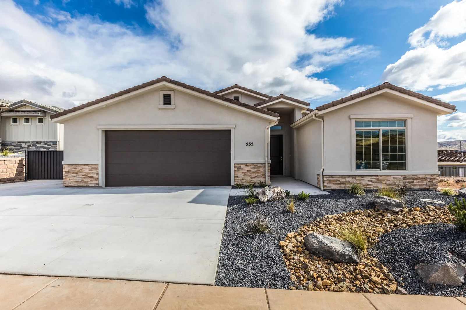 Single-story home with a stone base and a two-car garage
