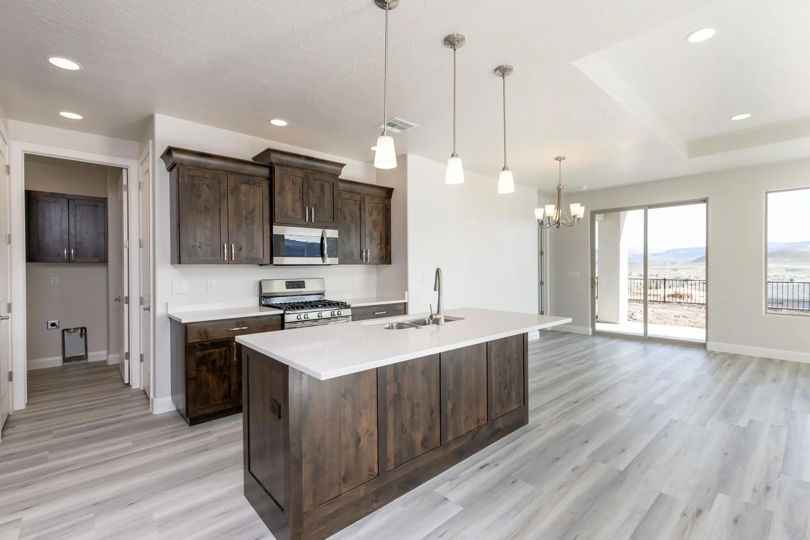 Kitchen island with dark cabinets and pendant lights