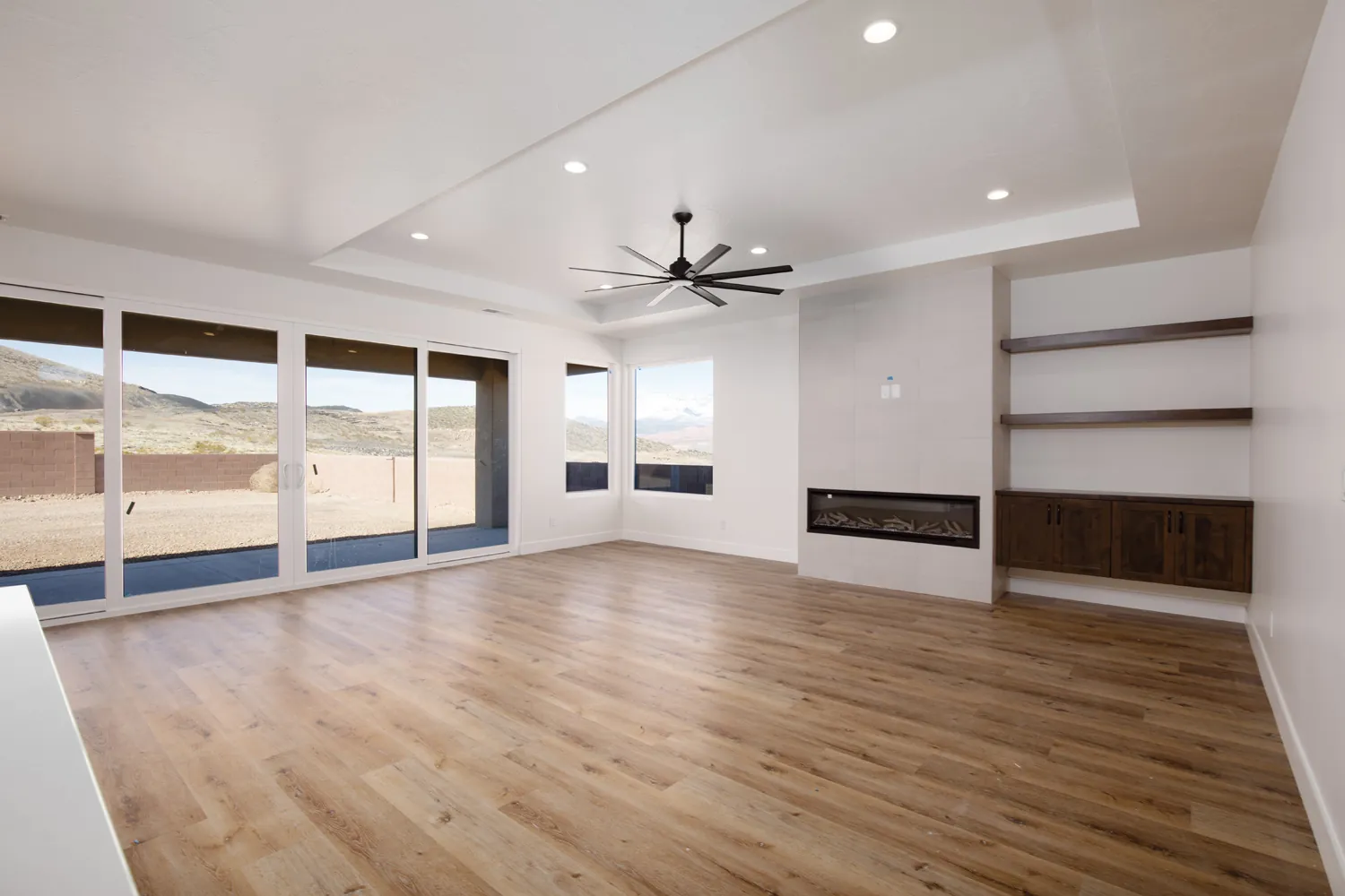 Great room with a linear fireplace and sliding doors