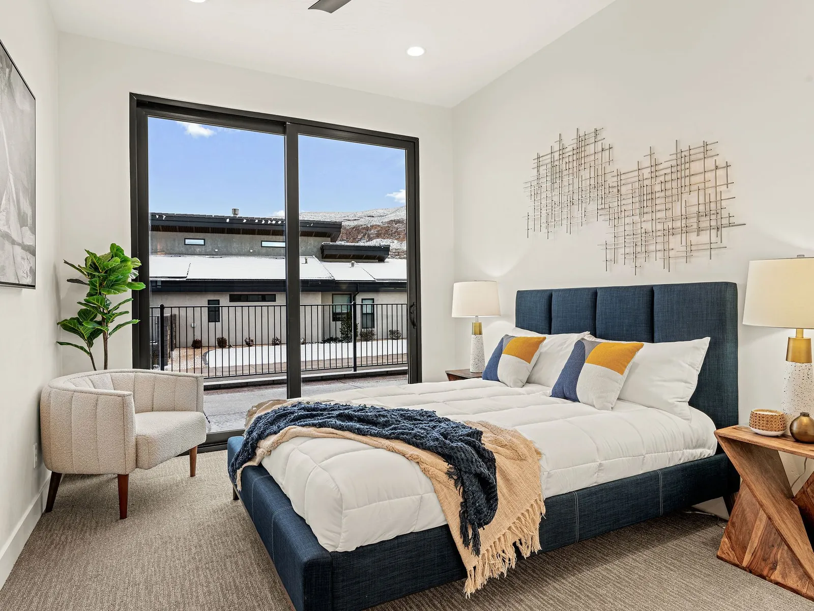 Bedroom with a navy headboard and a big window