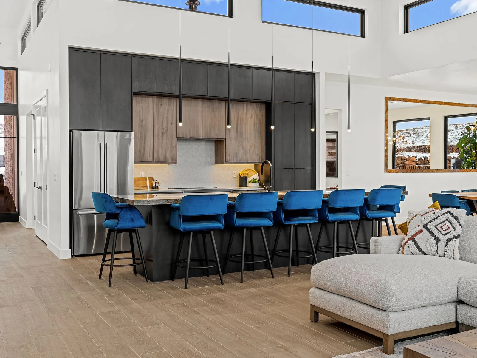 Long kitchen island with blue bar stools