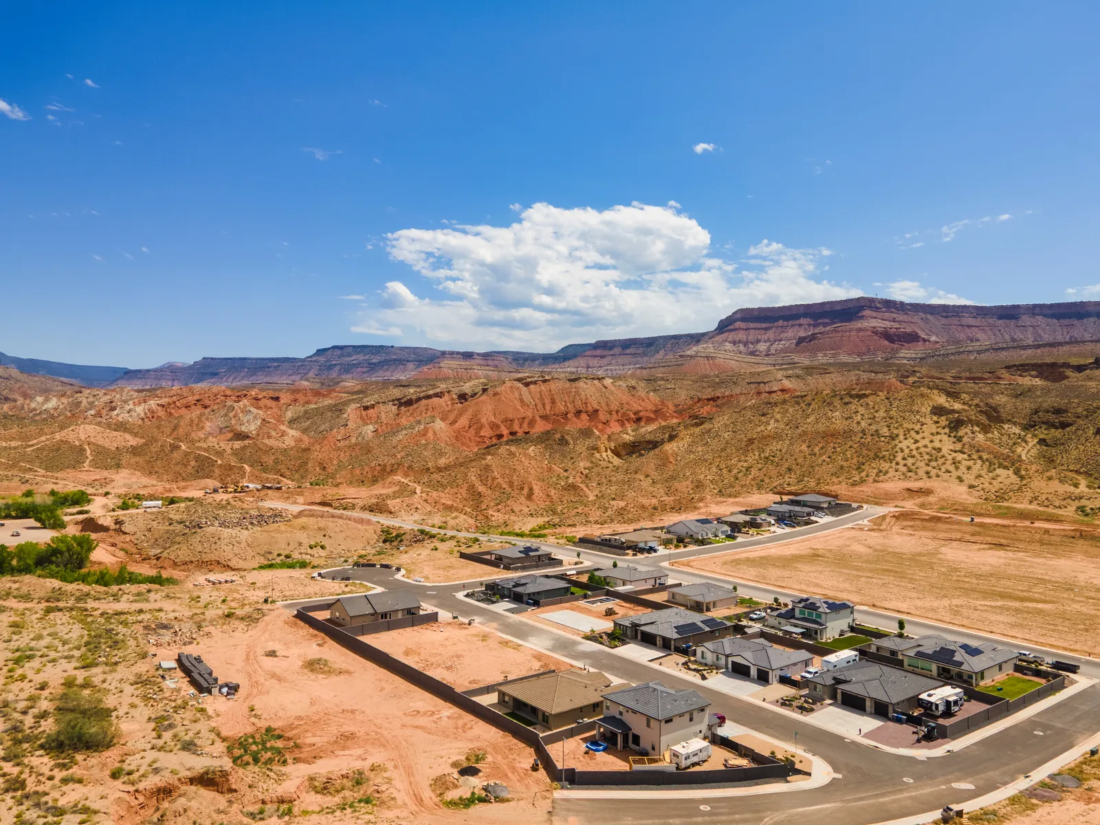 Aerial view over a La Verkin neighborhood toward the cliffs