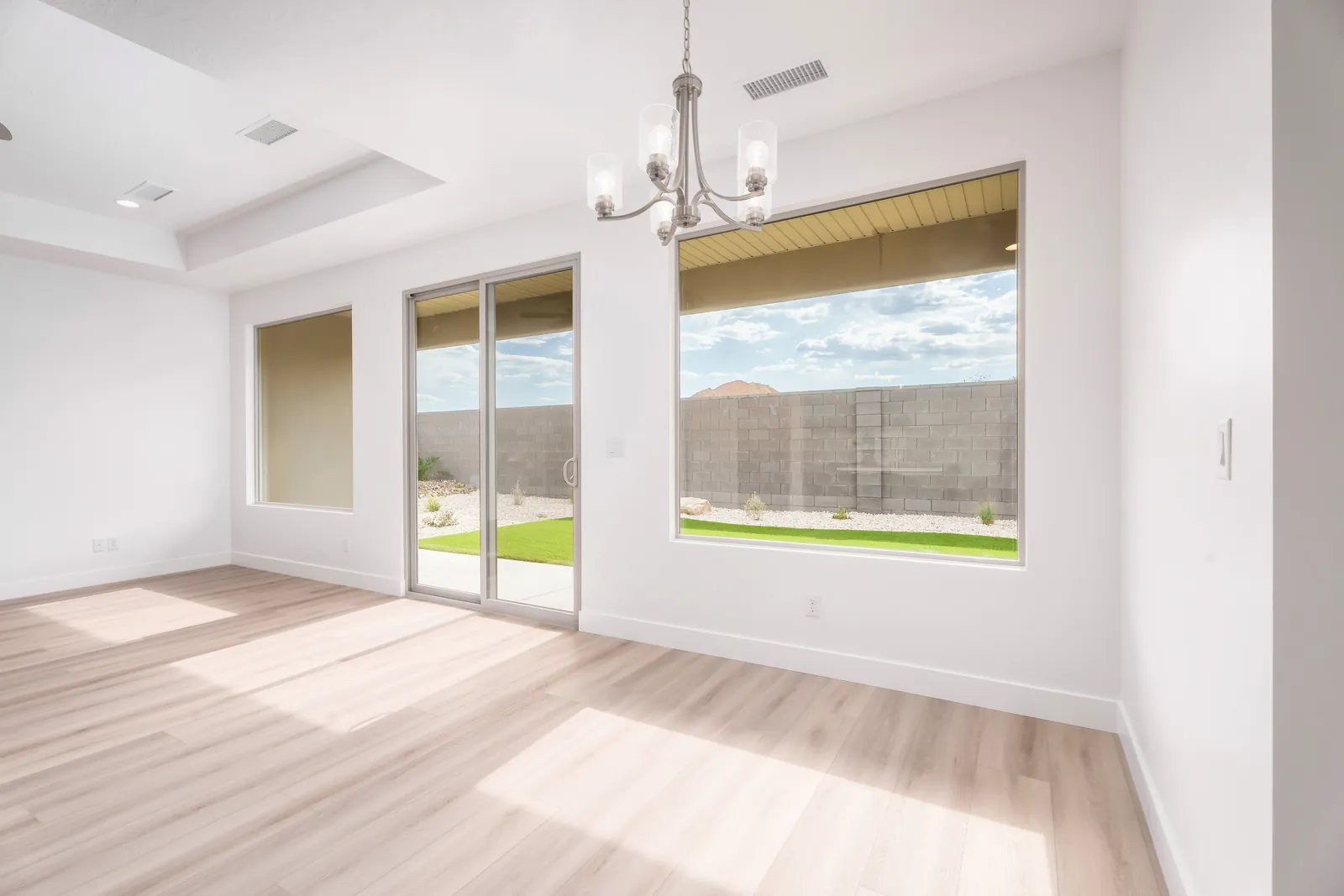 Dining area with a chandelier and sliding doors to the backyard