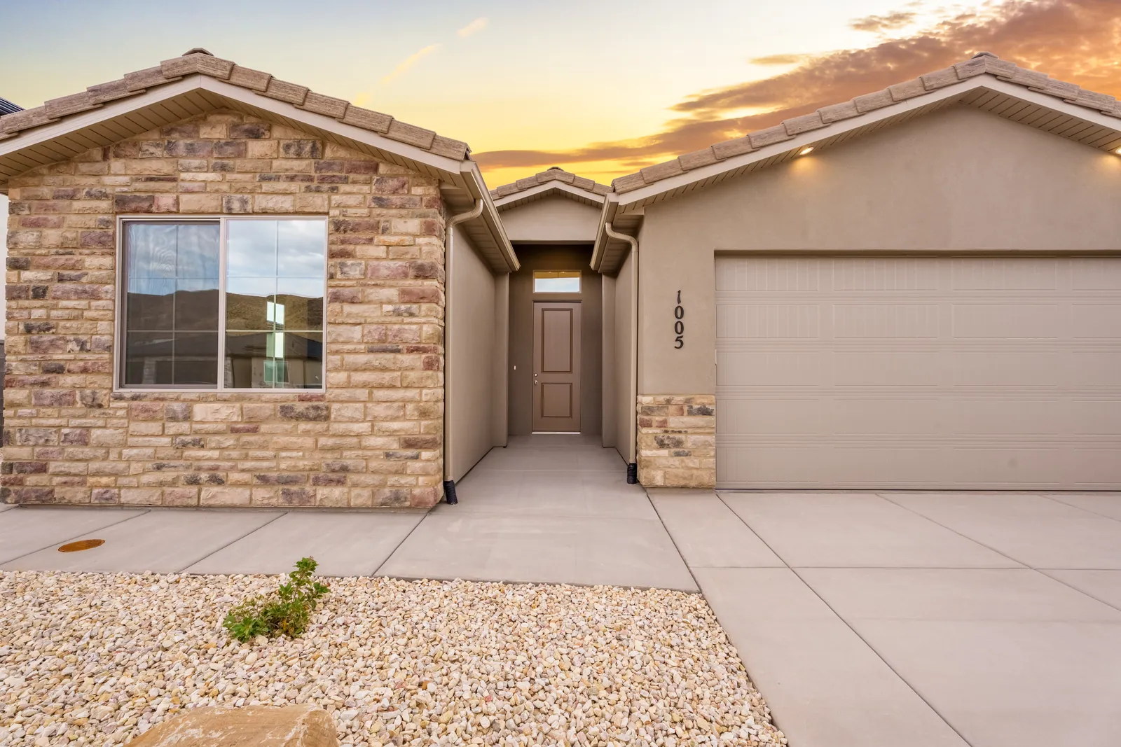 Front of a stone-accented home at sunset
