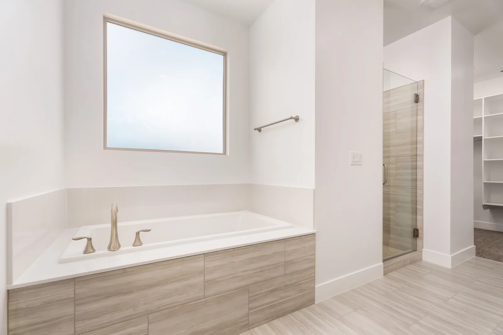 Soaking tub under a window in the primary bathroom
