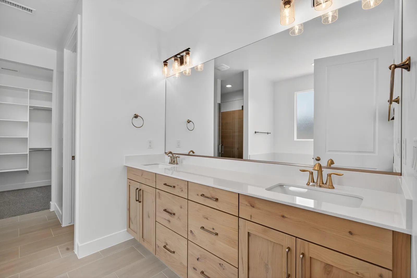 Double vanity with light wood cabinets