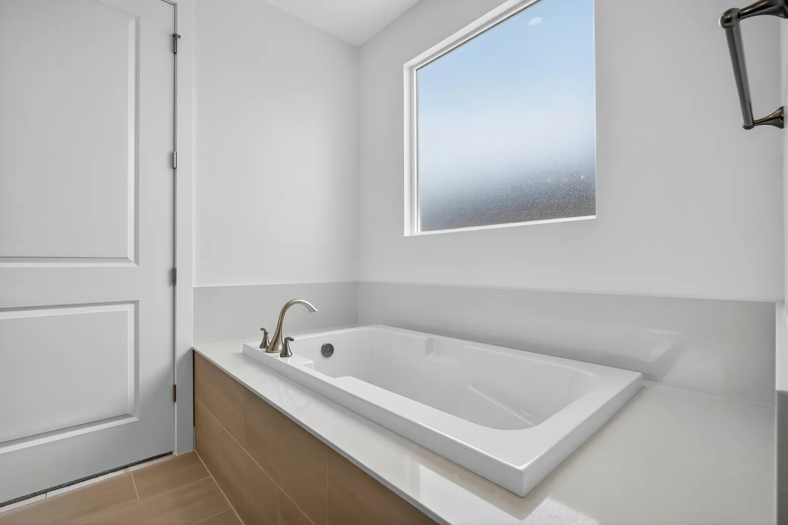 Soaking tub in a tiled primary bathroom