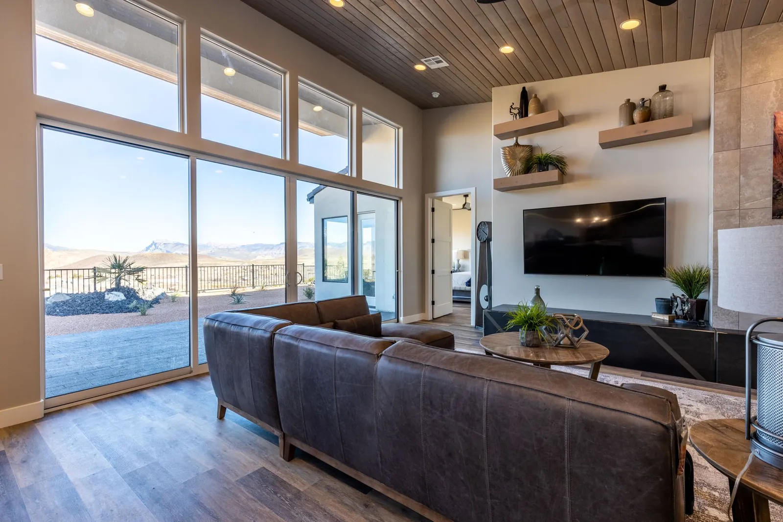 Great room with tall windows and a leather sofa