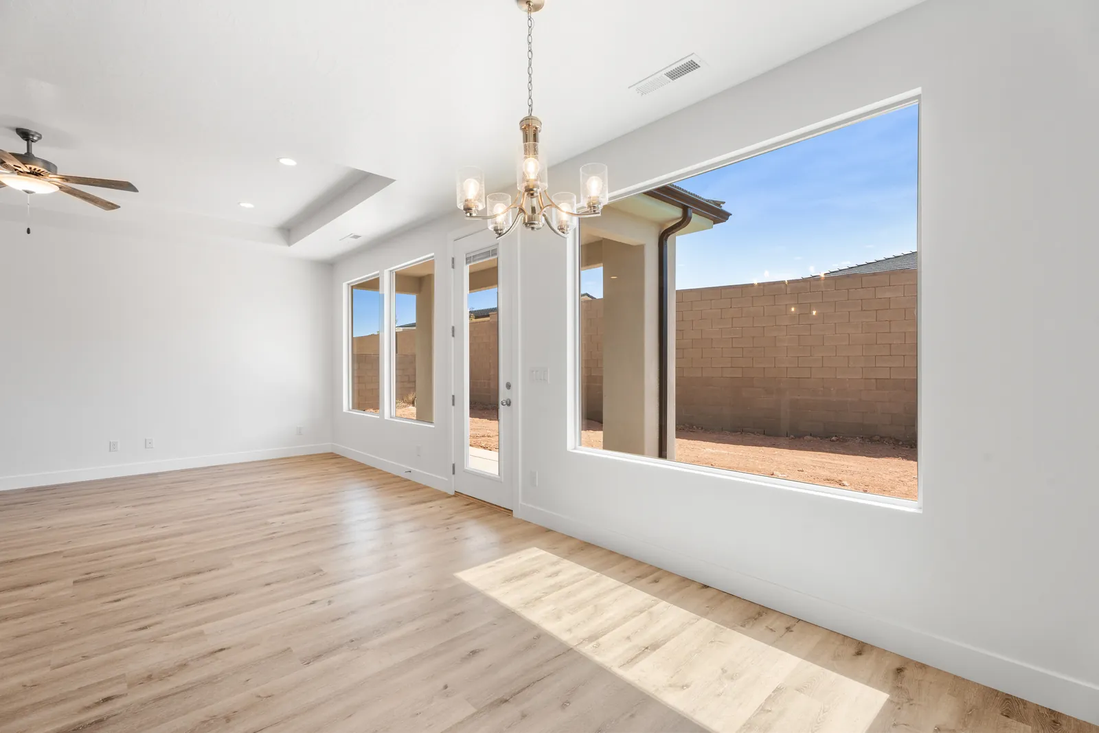 Dining area with a chandelier and large windows