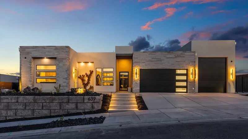Modern home at dusk with lit steps up to the front door