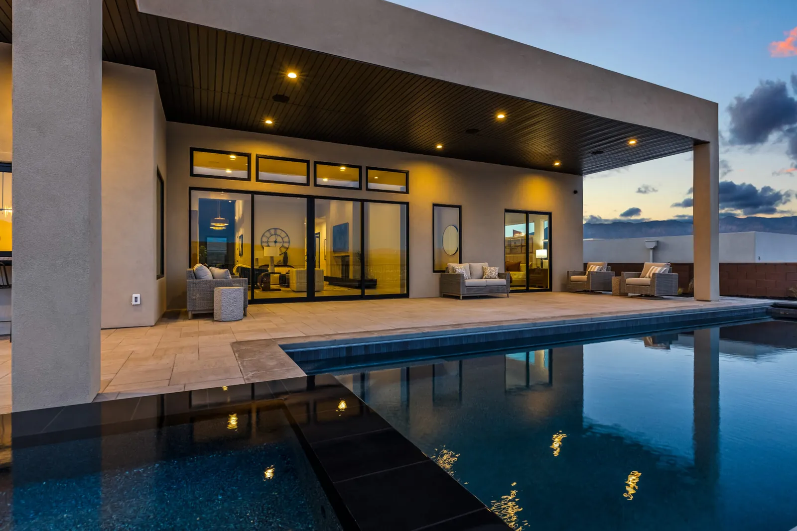 Covered patio and pool at dusk