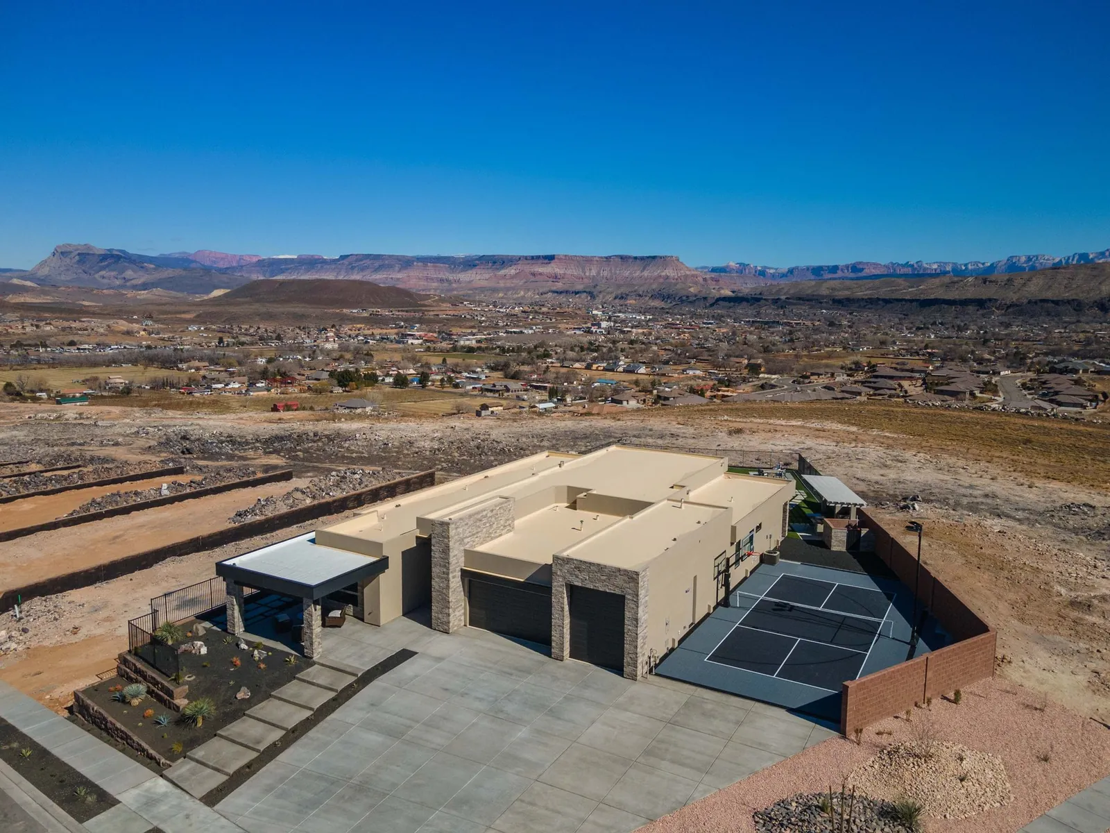 Aerial view of a home on a hilltop above the valley
