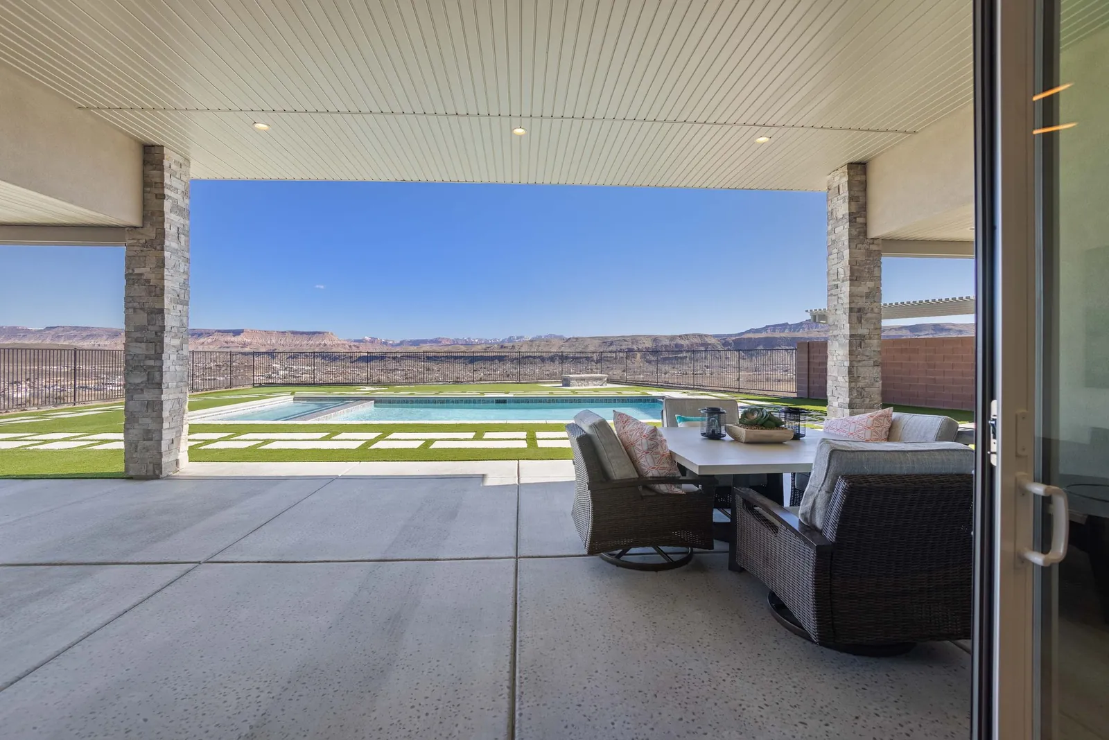 Covered patio looking out to the pool and the valley